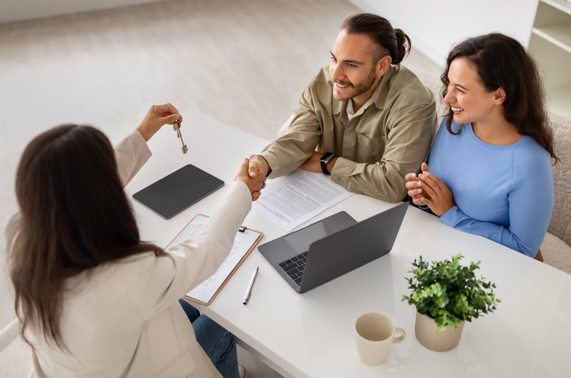 Property specialist showcasing home deals to a budding couple